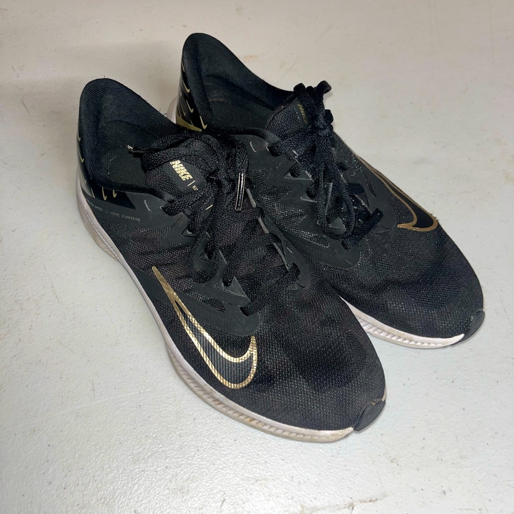 Black and gold women’s Nike shoes